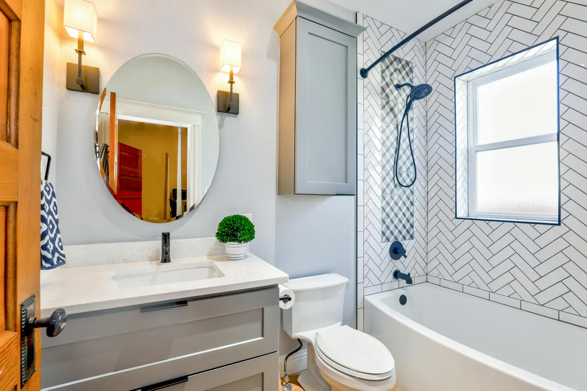 Herringbone tile bathroom renovation - quality craftsmanship by Bernhardt Projects Calgary