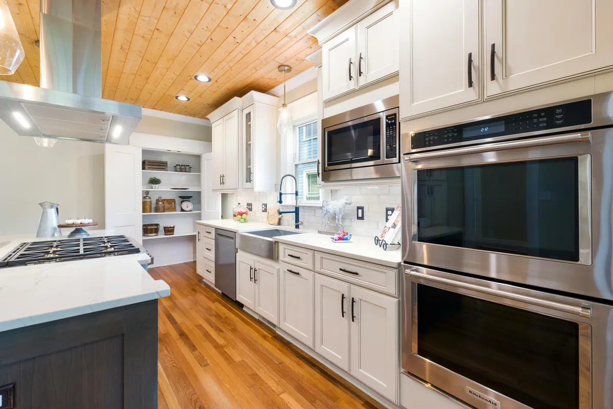 Calgary kitchen renovation by Bernhardt Projects - white cabinetry, wood ceiling, stainless appliances