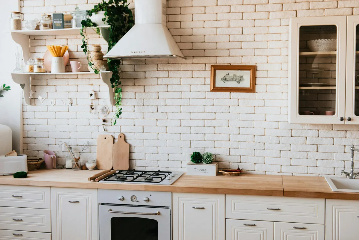 Warm kitchen design with exposed brick and butcher block counters - Bernhardt Projects Calgary